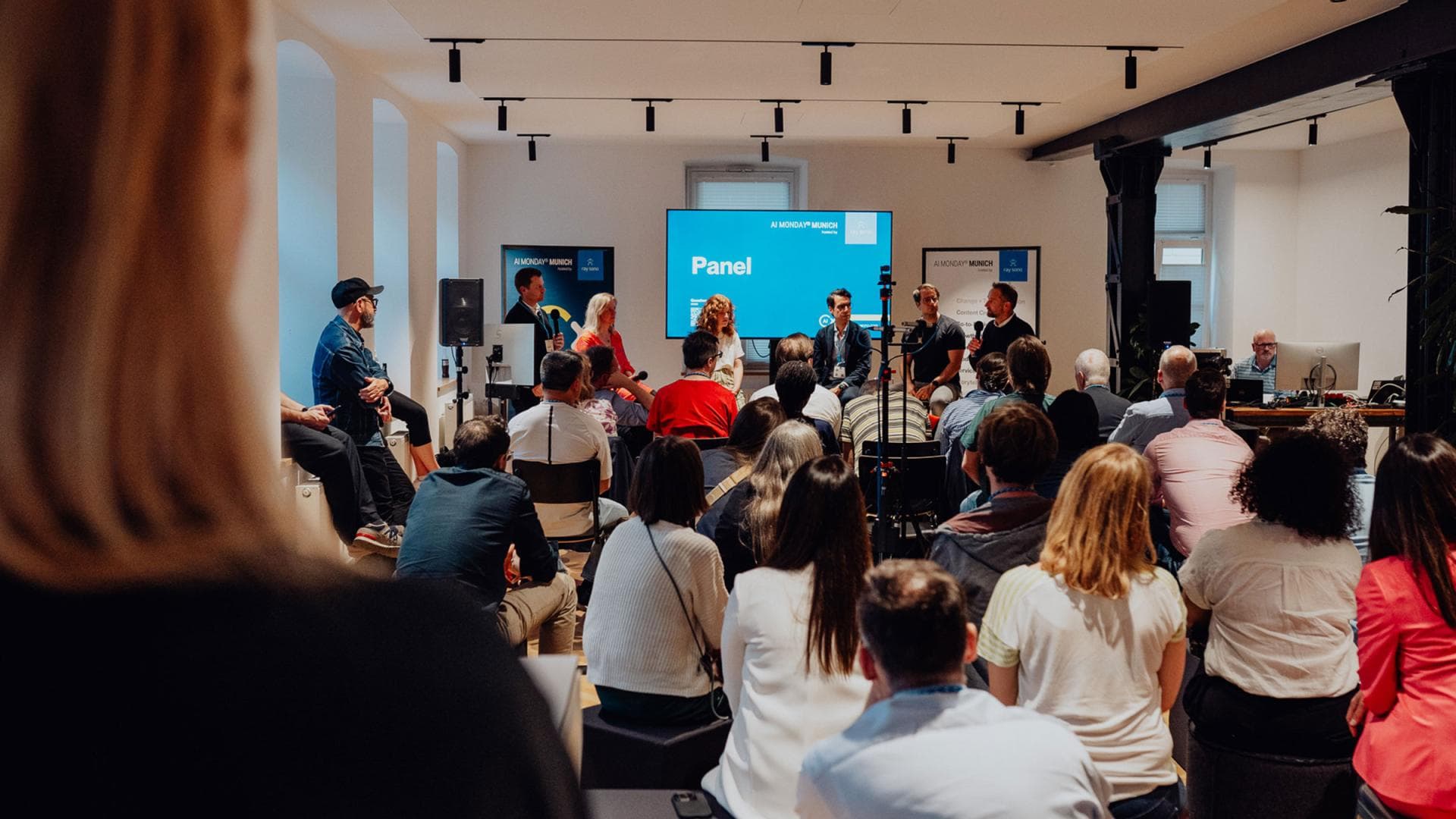 Industry experts in a panel discussion in front of an audience.